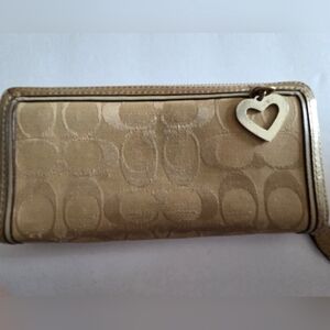 COACH PREOWNED ZIPAROUND GOLD WALLET.